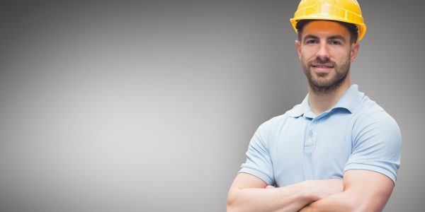 Portrait of worker standing with arms crossed Portrait of worker standing with arms crossed against grey background